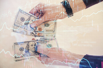 Multi exposure of financial graph drawing hologram and USA dollars bills and man hands. Analysis concept.