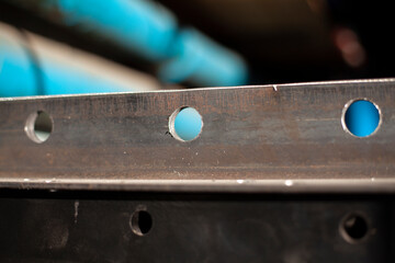 Drilled metal parts. Material in the workshop. Metal work.