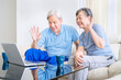 © Creativa Images - Old couple doing a video call with laptop at home