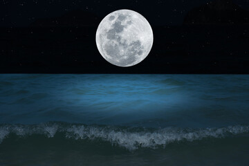 full moon over the sea at night.