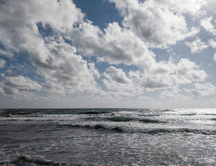 Coast of sea with clouds and sand of beach