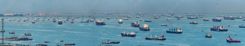 Wide panorama image of Container Ships and tankers anchored at the Singapore strait. - obrazy, fototapety, plakaty 
