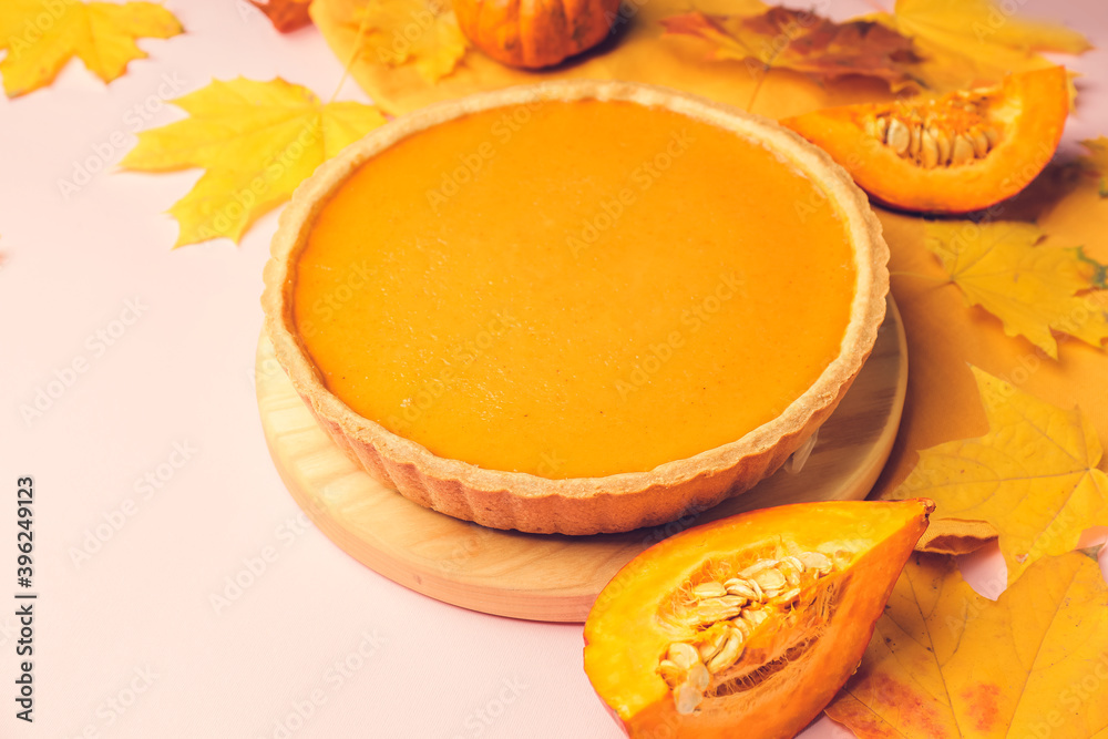 Tasty pumpkin pie on color background