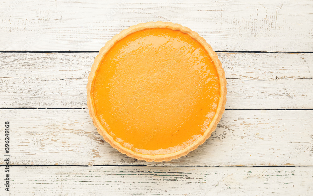 Tasty pumpkin pie on wooden background