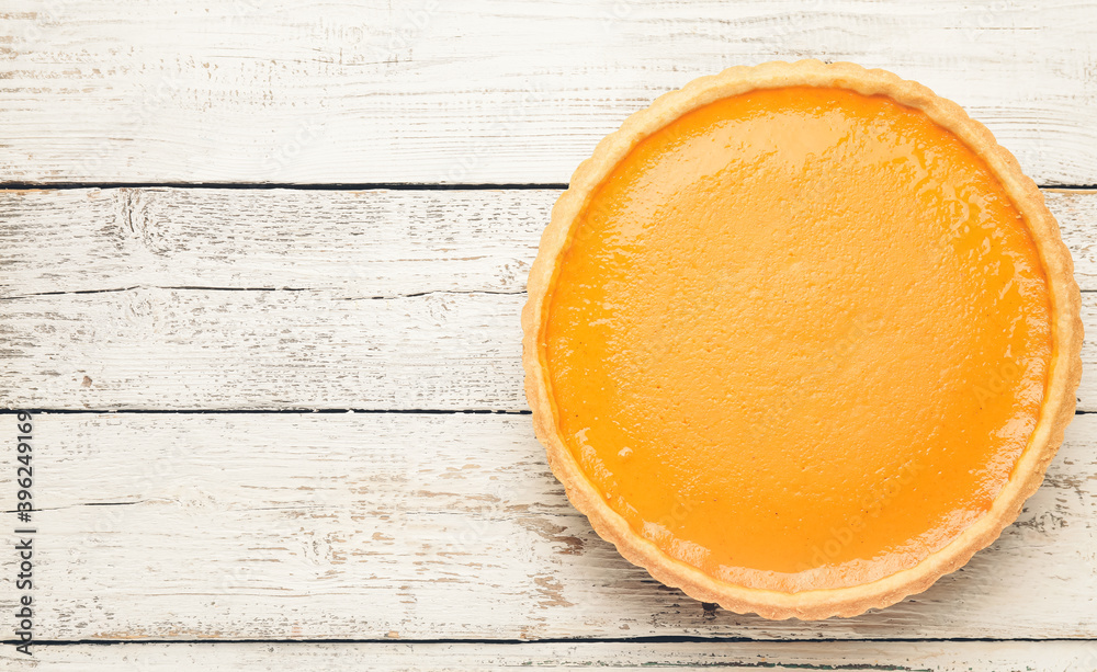 Tasty pumpkin pie on wooden background