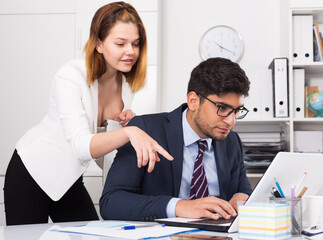 Focused business team working with computer in modern office