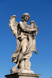 Fototapeta  - Angel with the Crown of Thorns on Ponte Sant Angelo bridge in Rome, Italy. Marble sculpture from 17th century by Naldini, design of Bernini