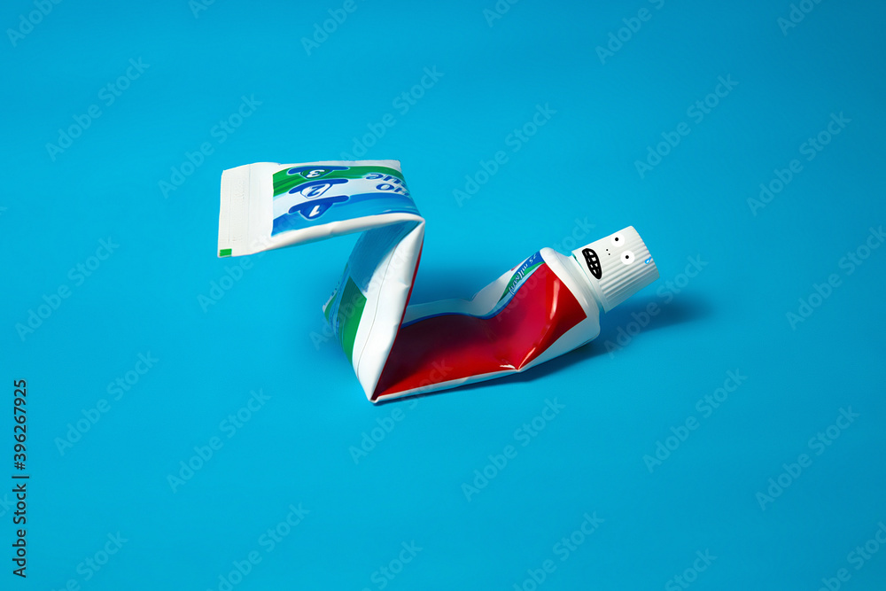 Colgate toothpaste, pumping the press. Funny and minimal color still life photography