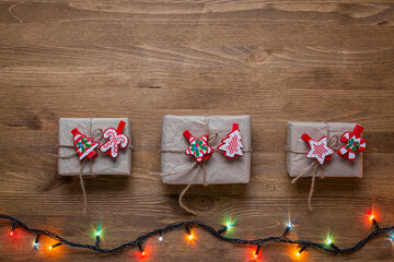 Wall Mural - Christmas concept with New Year gifts. Copy space framed by Christmas tree branches and decorations, top view