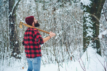 Lumberjack lifestyle. Handsome man working in forest.