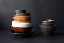 Still Life With Handmade Ceramic Dishware On A Black Background. Plates, Bowls, Pialas. Rustic Style.