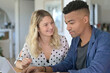 © goodluz - Mixed-raced couple connected on laptop at home