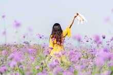 Traveler Or Tourism Asian Women Standing And Chill  In The Purple  Verbena Flower Field In Vacations Time.  People  Freedom And Relax In The Spring  Meadow.  