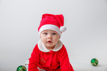 a baby in a Santa Claus costume on a white background