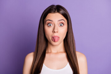 Canvas Print - Photo of funny young woman wear casual white outfit showing tongue big eyes isolated violet color background