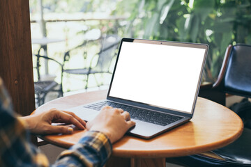 computer blank screen mockup.hand woman work using laptop with white background for advertising,contact business search information on desk at coffee shop.marketing and creative design