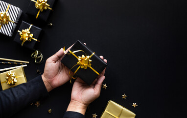 Wall Mural - merry christmas and new year celebration concepts with person hand holding gift box and ornament in 
