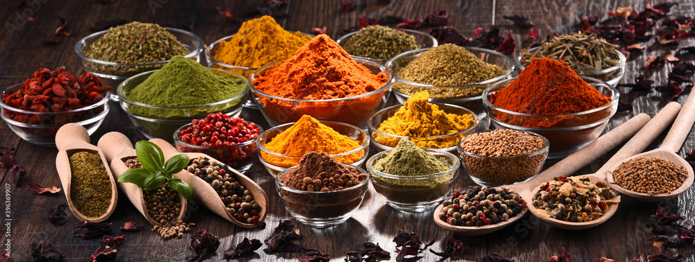 Variety of spices and herbs on kitchen table - obrazy, fototapety, plakaty 