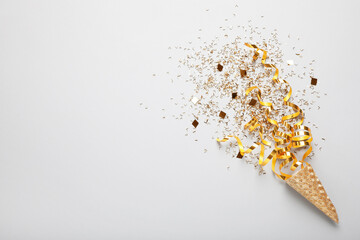 Wall Mural - Golden confetti and streamers with party cracker on white background, top view. Space for text