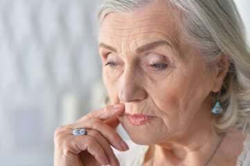 Canvas Print - Close up portrait of sad ill senior woman