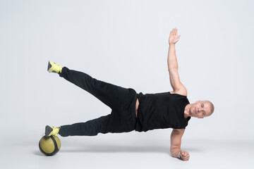 Wall Mural - sport man or bodybuilder exercising with medicine ball on white background