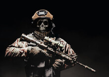 Photo Of A Fully Equipped Skeleton Zombie Soldier Standing In Armored Vest And Holding Rifle On Black Background.