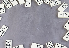 White Dominoes On Gray Background. Copy Space