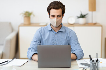 Poster - Businessman Wearing Face Mask Working On Laptop Sitting At Workplace