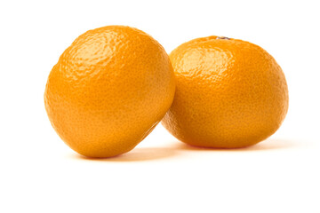 Two orange tangerines lined up on top of each other on an isolated background.