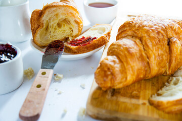 Wall Mural - croissant with berry jam on a white table