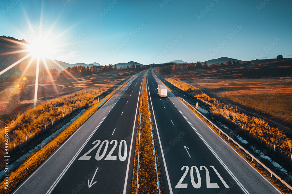 Driving on open road at beautiful sunny day to new year 2021. Aerial view - obrazy, fototapety, plakaty 