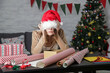 © triocean - Depressed frustrated woman wrapping Christmas gift boxes, winter holiday stress concept