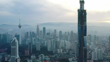 Wall Mural - Establishing aerial cinematic drone b-roll shot of sunrise at Kuala Lumpur city skyline