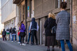 © Dragan - Belgrade, Serbia. Coronavirus pandemic effects: long queue to enter the pharmacy store for shopping. Covid-19