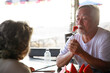 © sutthichai - Retired senior couple enjoying meal in restaurant.
