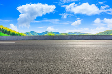 Asphalt road and green mountain with bamboo forest natural landscape.