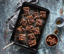 Sheet Pan Filled With Caramel Pecan Chocolate Chip Squares Ready For Eating.