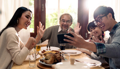 multigenerational asian family selfie and eating lunch together