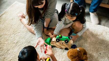 Wall Mural - Japanese family playing with toys on the floor