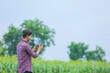© PRASANNAPIX - Young indian agronomist operate or control of flying drone at agriculture field