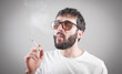 © andranik123 - Caucasian bearded man smoking cigarette.