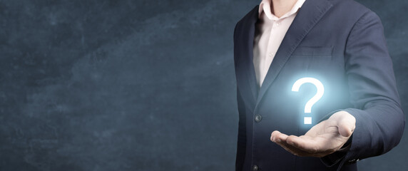 Fototapete - Businessman showing Question mark. man holds a glowing question mark in his hand. banner, blue background
