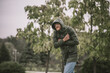 © zinkevych - Young bearded man in a hood going under the rain