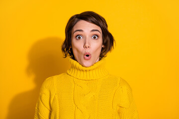 Poster - Photo portrait of shocked surprised female brunette staring with opened mouth in knitted sweater isolated on vivid yellow color background