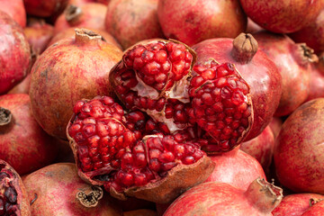 close up of pomegranate in fruit market with other pomegranate