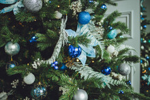 Close Up Of Christmas Trees Decoration With Toys And Garlands.