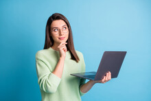 Minded Clever Girl Hold Laptop Look Empty Space Think Decisions Wear Green Pullover Isolated On Blue Color Background