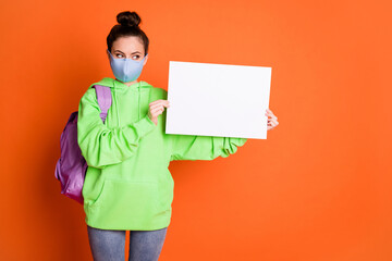 Sticker - Full body portrait of person arms hold poster look empty space green pullover bag isolated on orange color background