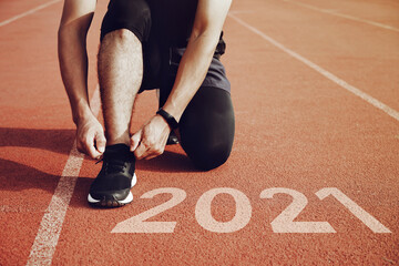 Wall Mural - Start to new year 2021 plans.Start of Man running on running court,with sunset light.Goal of Success concept