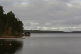 Fototapeta Desenie - Wooden sauna on the shore of a lake in Finland